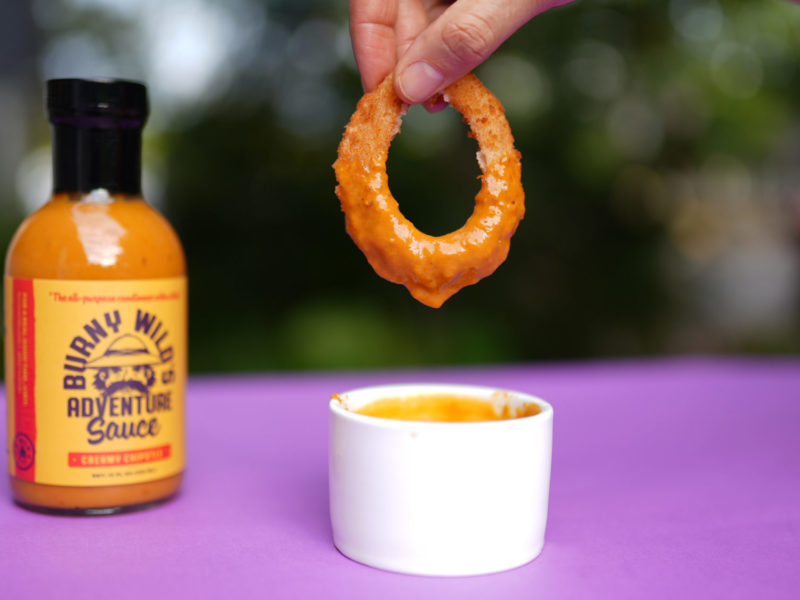 Crispy Onion Ring Dipped in Burny Wild's Adventure Sauce